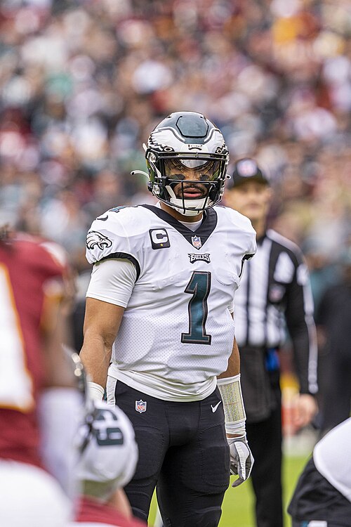 Jalen Hurts standing in a Philadelphia Eagles uniform in 2022. Player photograph, not card artwork.